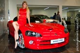 Девушка блондинка в красном платье и красный кабриолет купе Dodge Viper