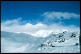 Фото горных склонов Приэльбрусья. Впереди - две вершины Эльбруса