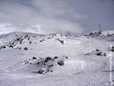 Фото горного склона с лыжными трассами в Терсколе