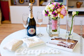 Шампанское Мартини на столе, бокалы, букет невесты, обручальные кольца на подушечке, чулки невесты, буквы «Свадьба»